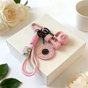 Pink fitness sports keychain detail showing dumbbells and barbell pendant, stylish design.