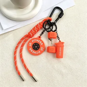 Fitness themed keychain detail, featuring orange paracord and cute dumbbell charms.