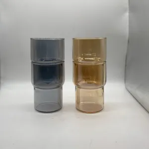 Dettaglio ravvicinato di bicchieri impilabili in vetro stile bambù grigio e ambra