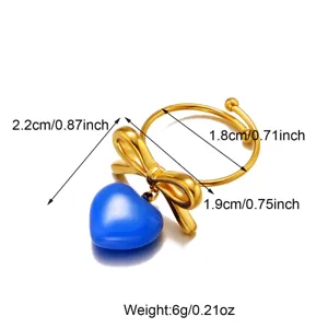 Detailed specification view of a gold bow ring with a vibrant blue heart enamel charm