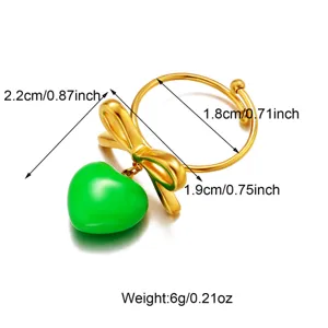 Detailed view of golden bow ring with green heart pendant showing precise dimensions and weight