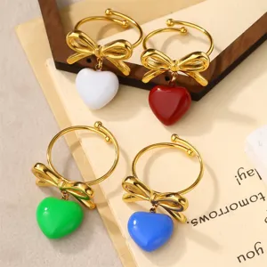 Set of adjustable titanium steel rings with bow and colorful enamel heart charms.