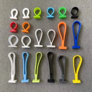 Kleurrijke siliconen handvatten en zachte ophanghaken voor verpakkingsdozen in diverse kleuren.