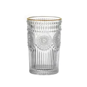 Elegant vintage embossed glass water cup with gold rim and sunflower pattern texture