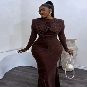 Detail shot of elegant ruched slim-fit long sleeve maxi dress in solid brown color.