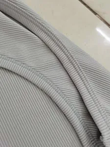 Macro view showing the high-quality ribbed fabric texture and fine stitching detail of grey dress