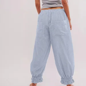 Back view of women's blue striped loose casual trousers with ruffled elastic cuffs and back pockets.
