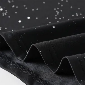 Close up detail view of the black fabric with white star pattern and neat stitching work.