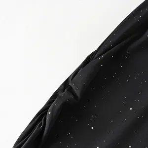 Close-up detail of black sparkly fabric featuring fine silver glitter for stylish women skirt.