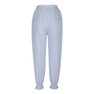 Detailed view of the back of light blue striped casual pants, showing elastic waist and ruffle hem.