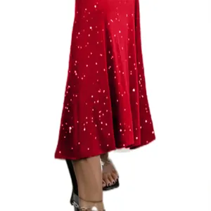 Red sequin fish-tail skirt detail view, sparkling glitter midi skirt hemline display.