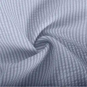 Blue white striped seersucker fabric texture close-up, soft cotton textile detail shot.