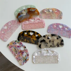 Acetate heart cutout hair combs in various colorful marble and floral pattern designs