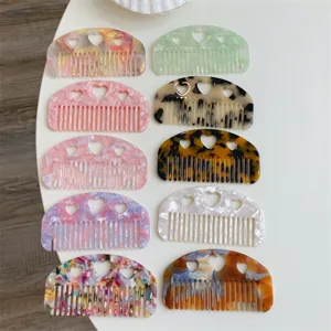 Assortment of mini portable acetate hair combs with sweet heart hollowed-out designs