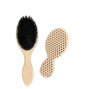 Boar bristle hairbrush with chic polka dot pattern for scalp massage and hair detangling