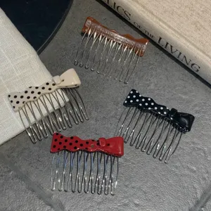 Detailed view of sweet polka dot bow hair combs in cream, red, black and brown tones