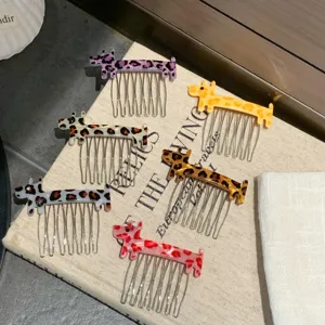 Detail view of six cute dog-shaped acetate hair combs with colorful leopard patterns.