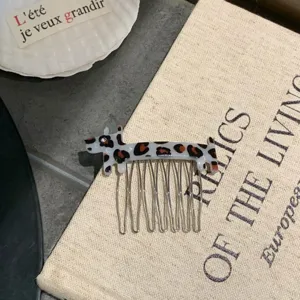 Close-up view of a cute leopard print dog acetate hair comb with shiny metal prongs