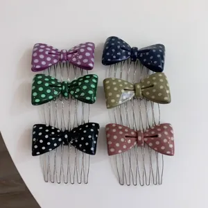 Detailed view of six colorful polka dot acetate bow hair combs with metal teeth in set.