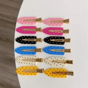A set of twelve colorful polka dot hair clips in vibrant macaron shades for styling