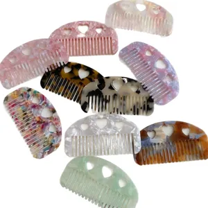 Set of small acetate hair combs featuring heart cut-out designs in assorted colors