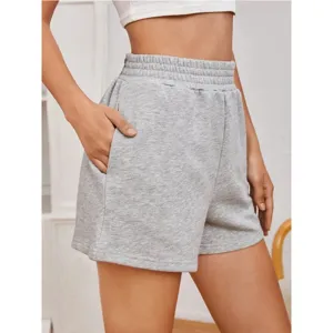 Close-up detail of grey loose-fit athletic shorts featuring comfortable elastic waistband.