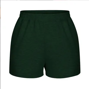 Close-up front view of dark green women's elastic waist athletic shorts with loose wide-leg fit