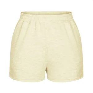 Detailed view of women's loose high-waist sports shorts in soft light yellow color