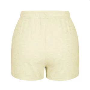 Back view of pale yellow women's loose casual sports shorts with elastic waist.