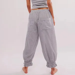 Detailed view of women's casual striped loose pants with elastic waist and ruffles.