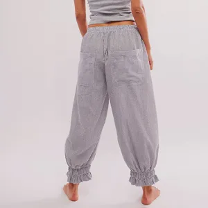 Close-up detail view of women striped casual pants featuring high elastic waist and cute ruffle cuffs.