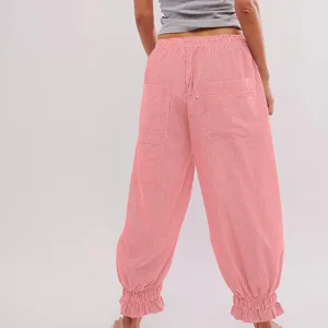 Detail view of pink striped casual trousers featuring cute ruffled cuffs and back pockets.