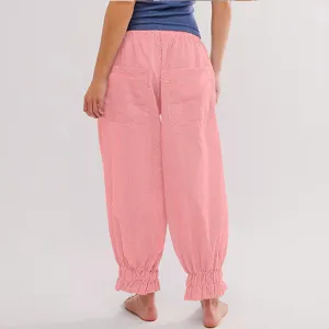 Detail view of pink striped casual pants featuring an elastic waist and cute ruffle ankles.