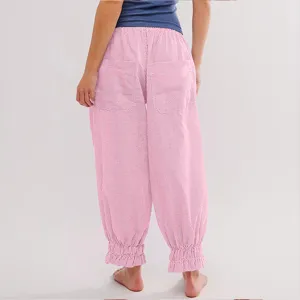 Detail view of women's pink striped casual pants featuring high elastic waist and ruffled cuffs.