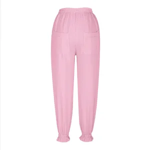Detailed view of women's pink casual pants, featuring elastic lettuce edge waist and cuffs.