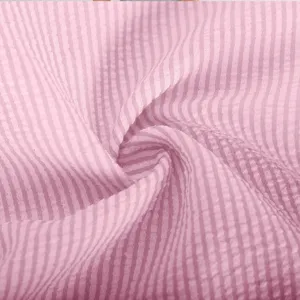 Pink striped fabric detail close-up, showing soft crinkled texture for summer wear.