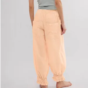Women loose casual pants with elastic waist and ruffled ankles, comfortable spring summer wear.