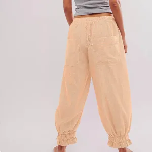 Detailed back view of casual striped women's trousers with elastic ruffle waist and back pockets.