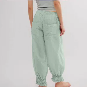 Detail shot of casual trousers showing back pockets, elastic waist, and ruffled cuffs.