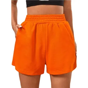 Women's high waisted elastic sports shorts in vibrant orange with wide leg design