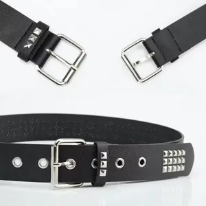 Detailed view of punk style black leather belt with silver pyramid studs and eyelets.