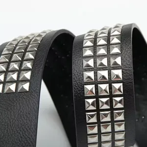 Macro detail of silver pyramid studs inlaid on a high-quality black leather strap