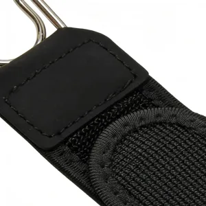 Detail shot of black outdoor tactical belt strap with metal hook, rubber patch, and velcro.