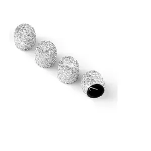 Close-up detail shot of sparkling rhinestone tire valve caps, crystal car stem decoration.