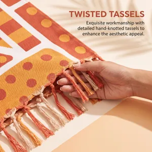 Close-up detail of hand-knotted twisted tassels on orange geometric beach towel bag