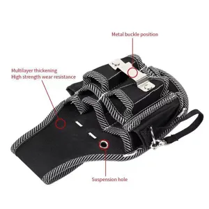 Detail view of multi-layer durable canvas tool pouch with metal buckle and hanging hole.