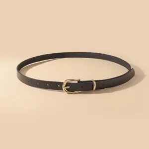 Detail view of the black thin leather belt with a sleek gold-toned metal pin buckle.