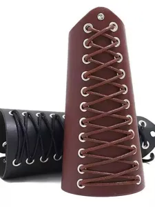 Detail shot of punk style wide leather wristband featuring cross lacing and metal eyelets.