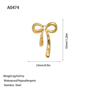 Macro detail of hammered golden bow pendant with full measurement and weight specs