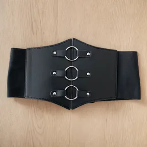 Detailed view of black PU leather wide corset belt with triple silver ring buckles